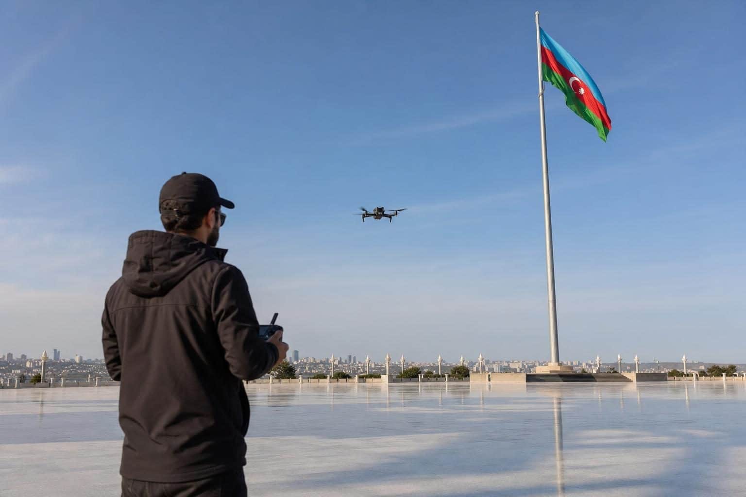 Male drone operator holding controller, National Flag Square, Baku