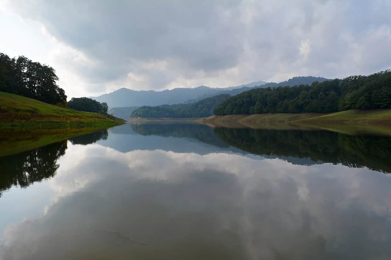 Khanbulan Lake reflecting the forested hills near Lankaran, Azerbaijan