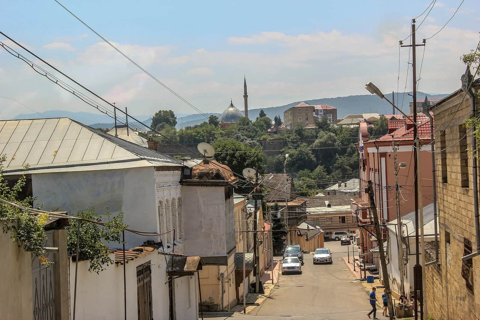 The dome and minaret of Quba's Juma mosque, seen across the valley from a street in Krasnaya Sloboda