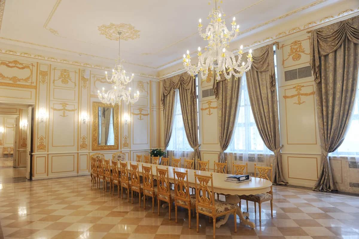 Chandeliers, cream and gold walls and ceremony seating inside the Palace of Happiness in Baku