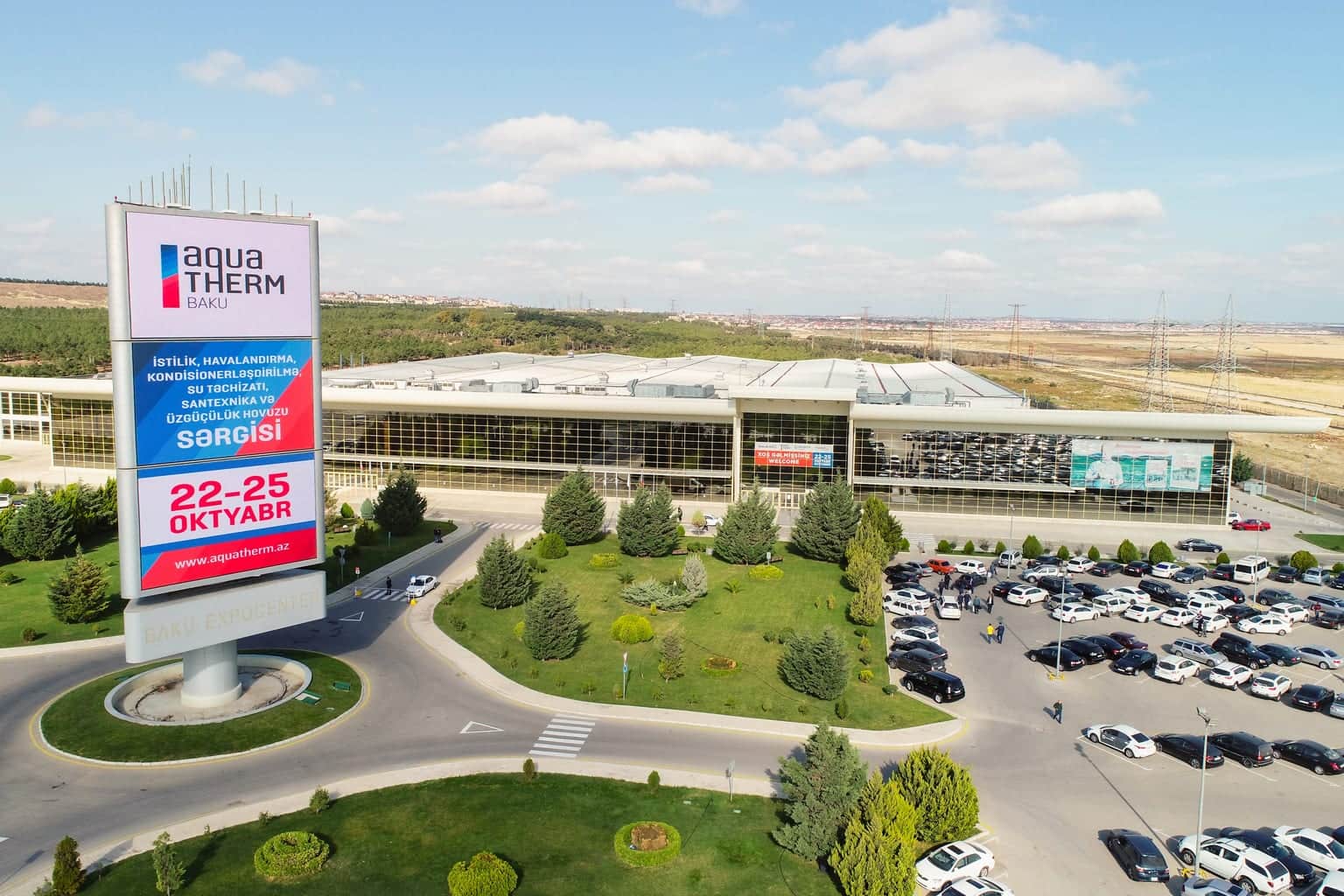 Aerial view of Baku Expo Center with its exhibition billboard and the car park during a trade show