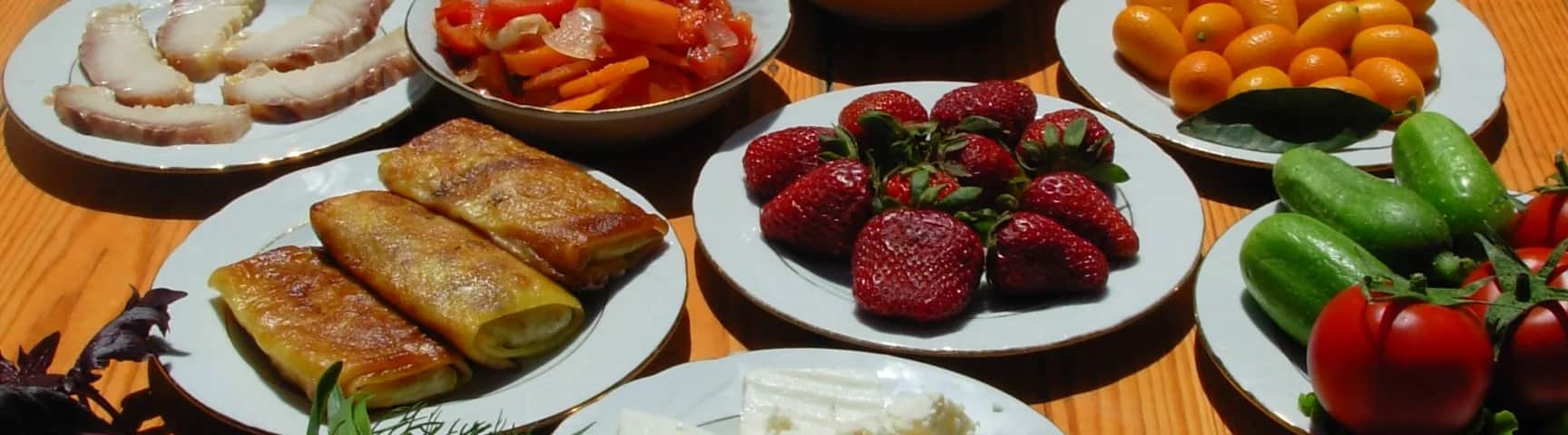 A spread of Azerbaijani snacks and produce on a dining table