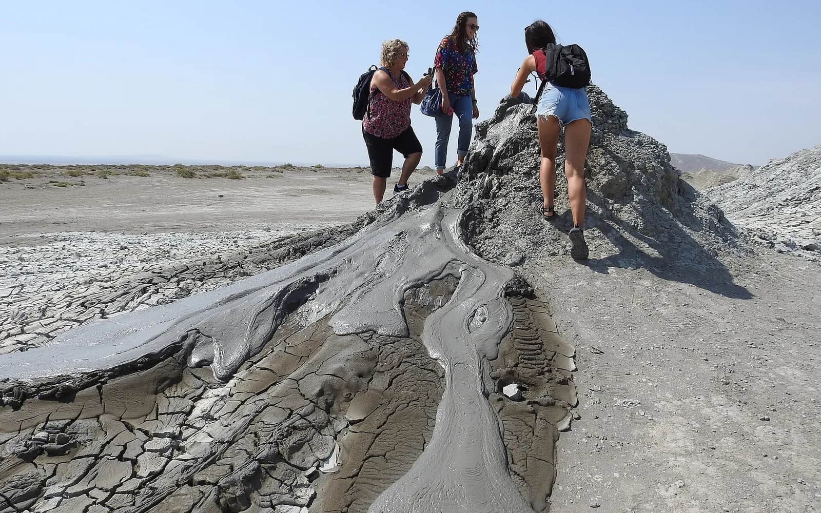 Visitors looking at a mud volcano in Gobustan, Azerbaijan