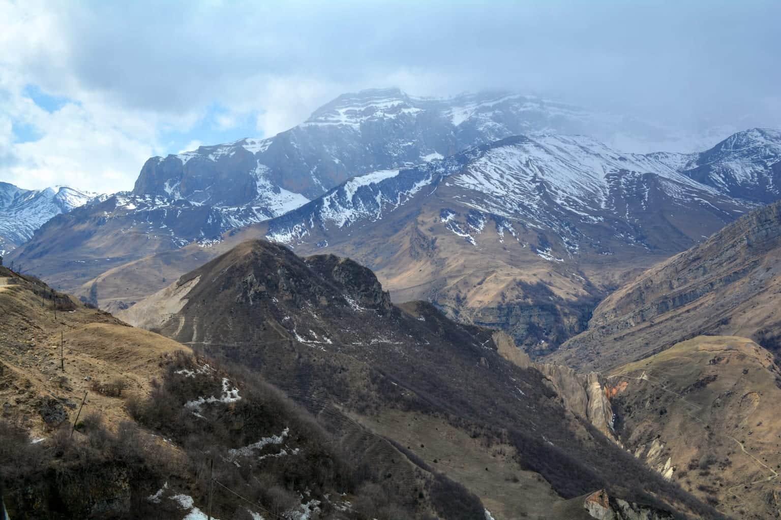 Snow-covered Greater Caucasus ridge above the valley approach to the Shahdag mountain resort