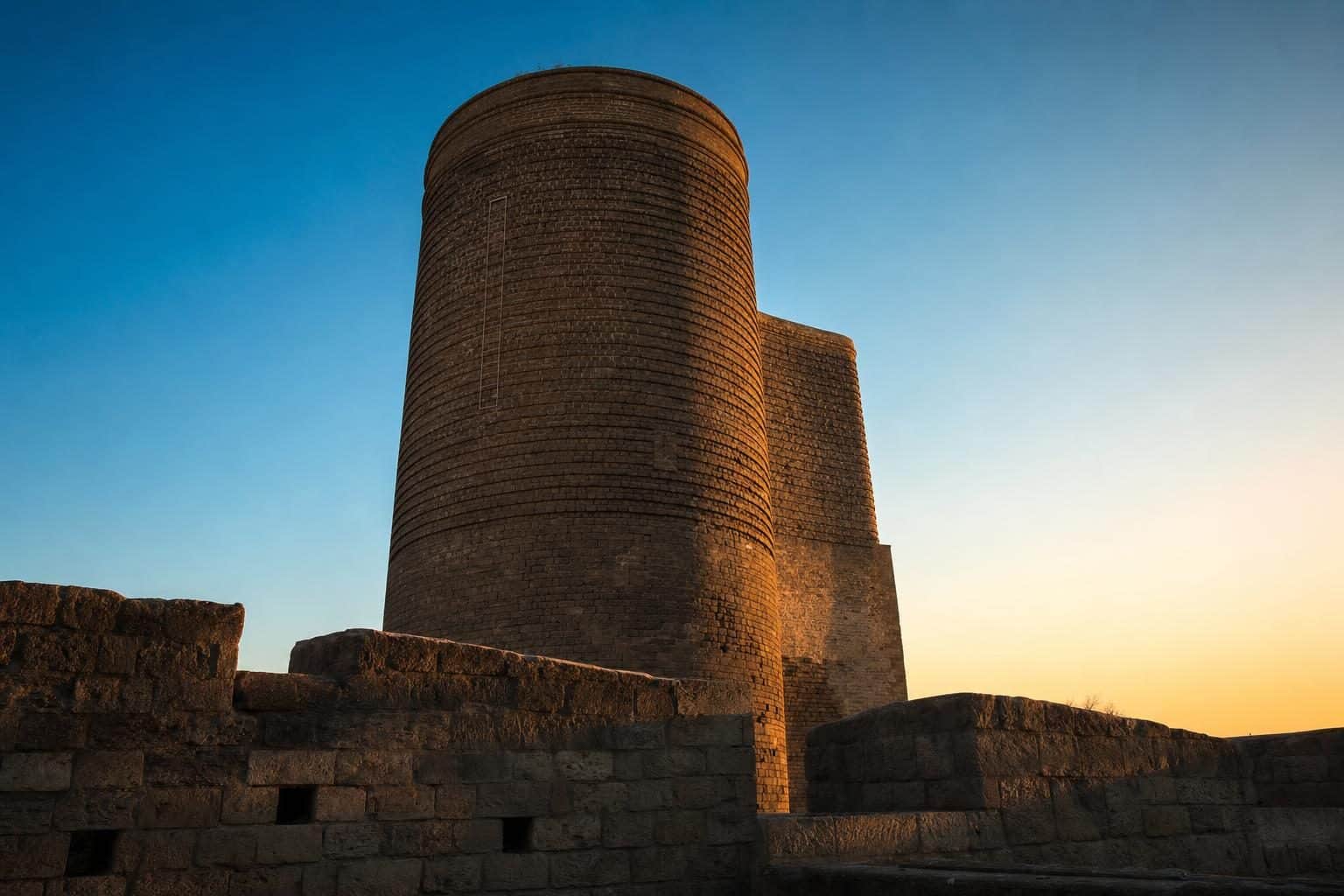 The medieval cylindrical sandstone tower from low-angle, Maiden Tower, Baku