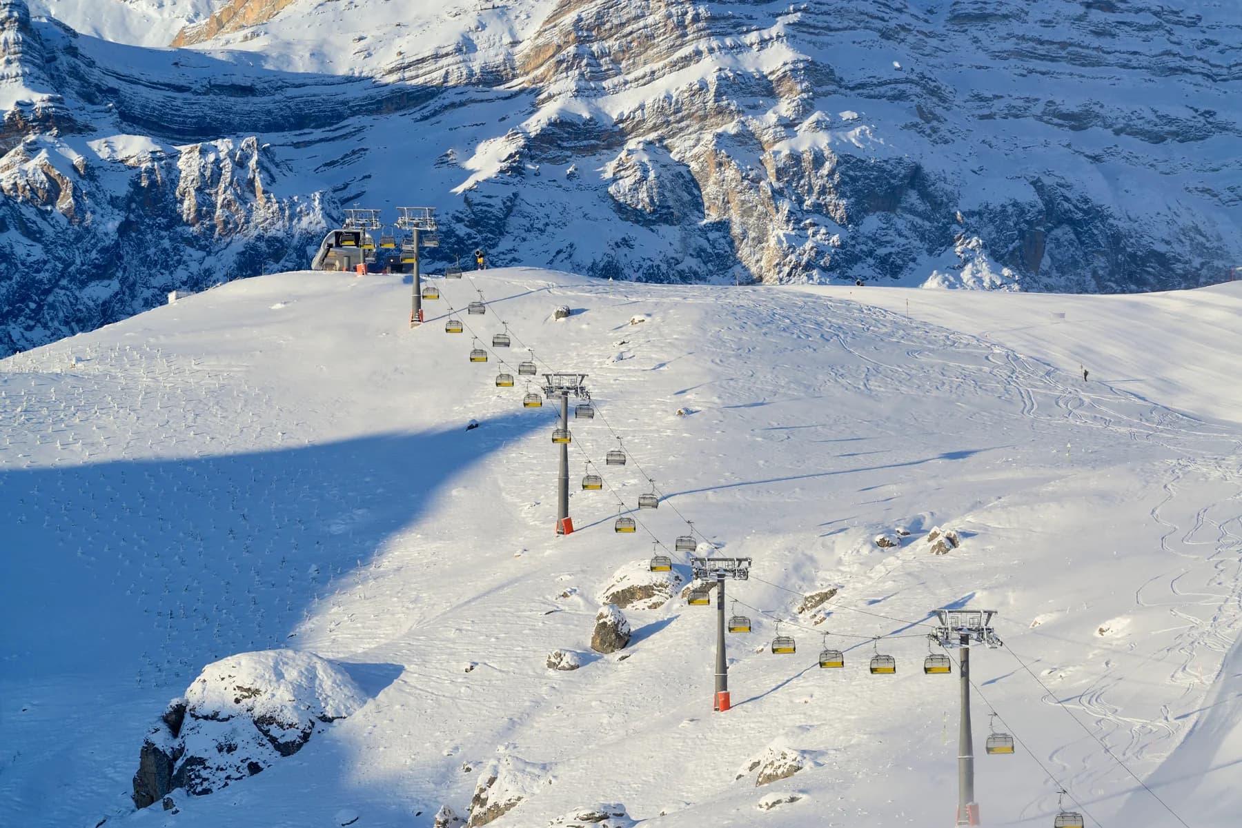 A chairlift over snow-covered slopes at Shahdag