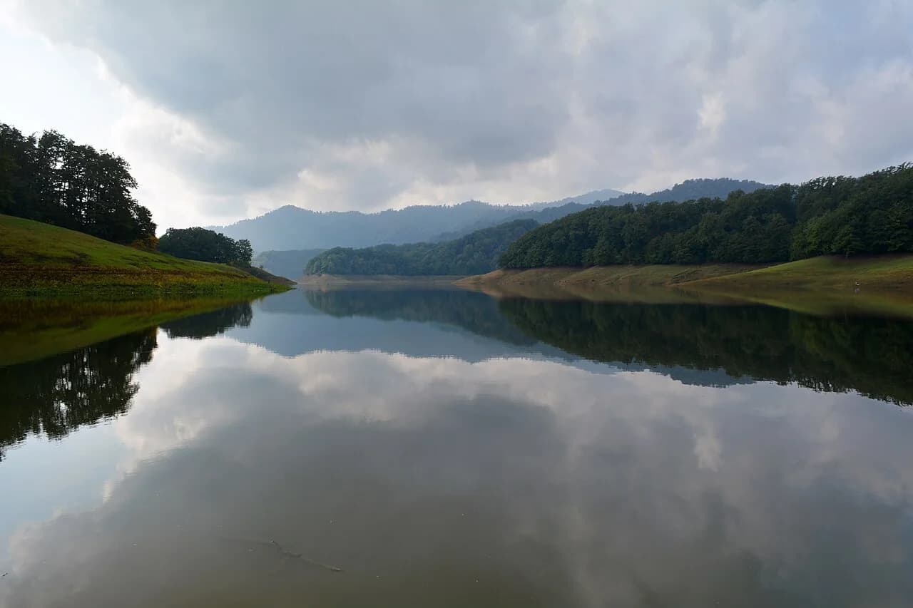 Khanbulan Lake reflecting the forested hills near Lankaran, Azerbaijan