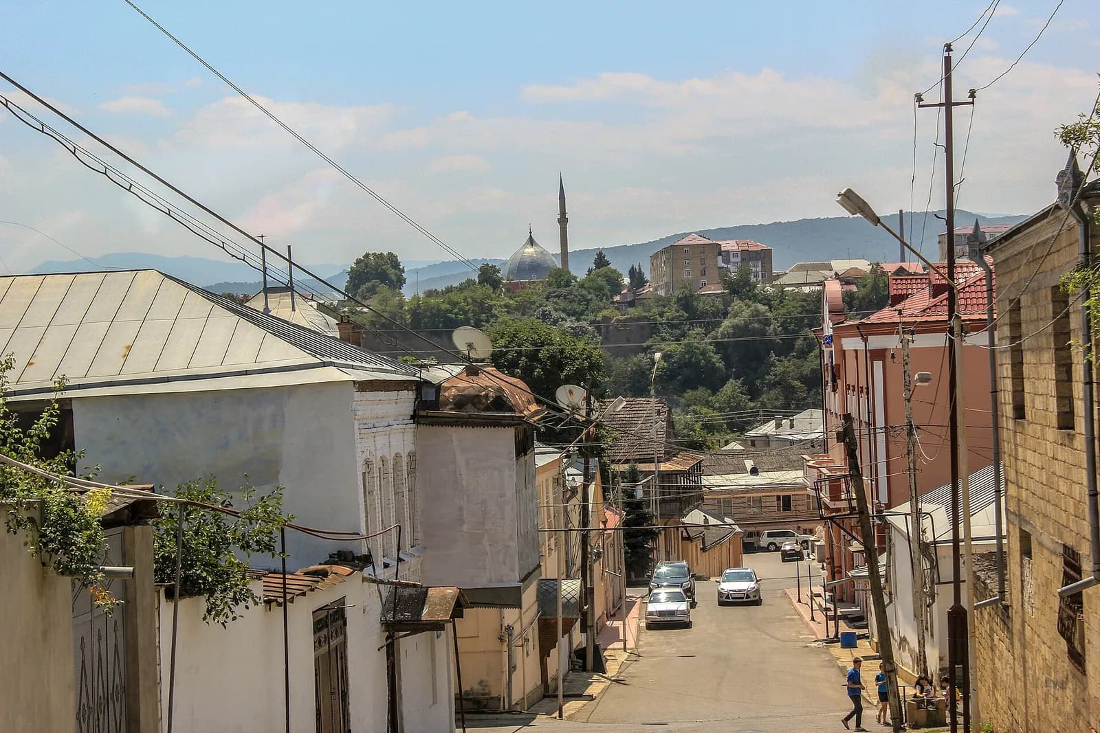 The dome and minaret of Quba's Juma mosque, seen across the valley from a street in Krasnaya Sloboda