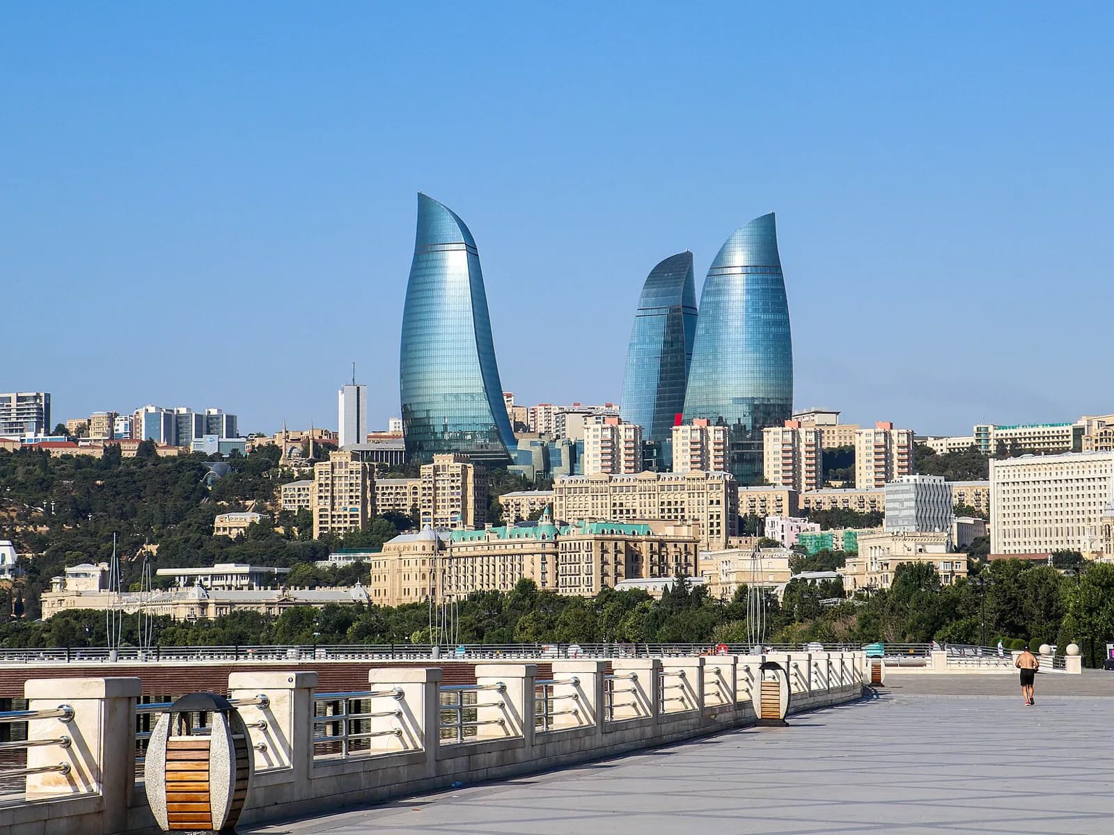 Broad paved section of Baku Boulevard with the Flame Towers in the distance