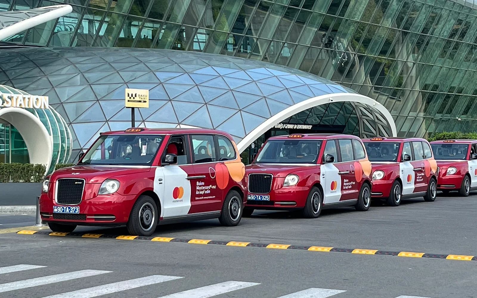 Red airport taxis lined up outside Heydar Aliyev International Airport in Baku