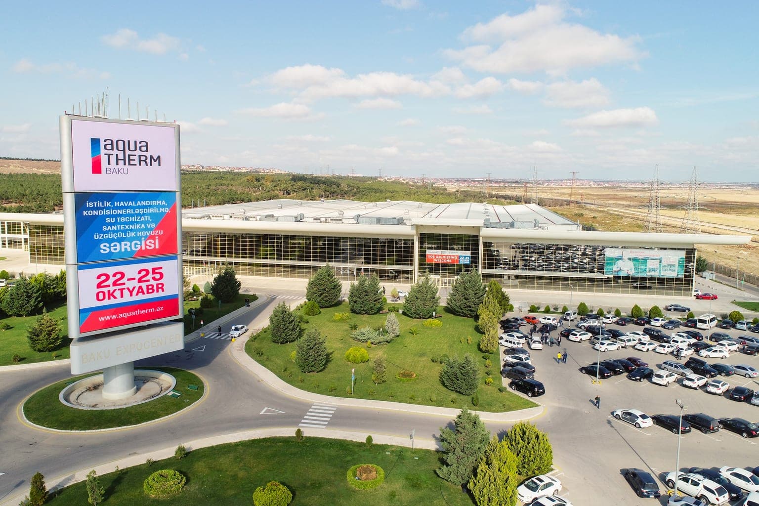 Aerial view of Baku Expo Center with its exhibition billboard and the car park during a trade show