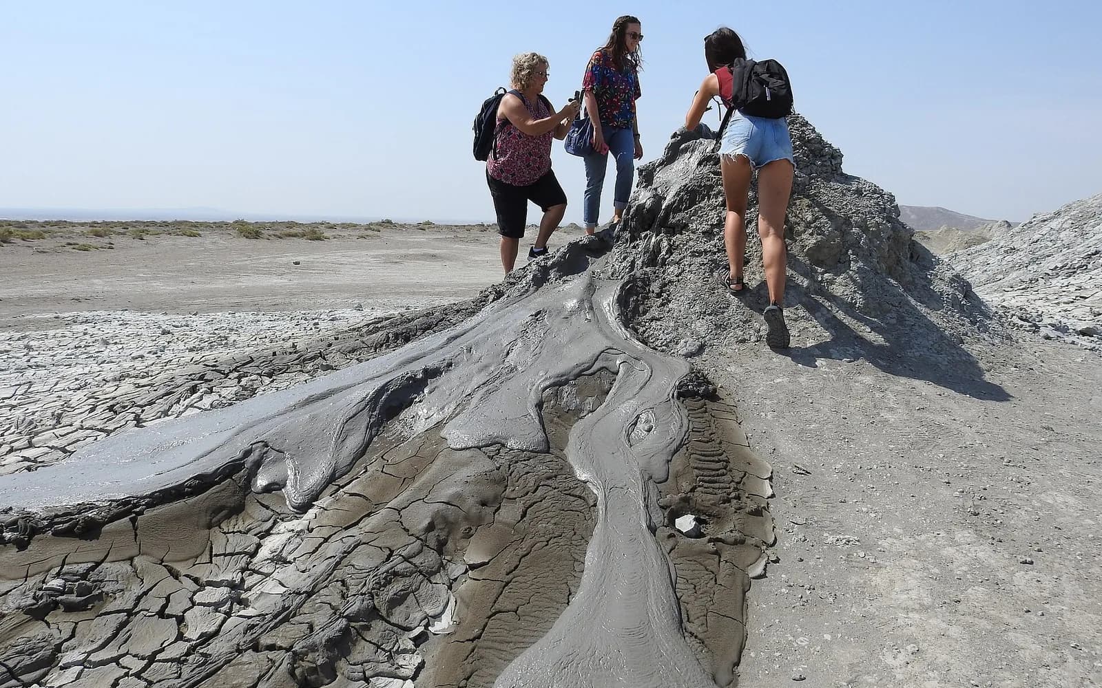 Visitors looking at a mud volcano in Gobustan, Azerbaijan