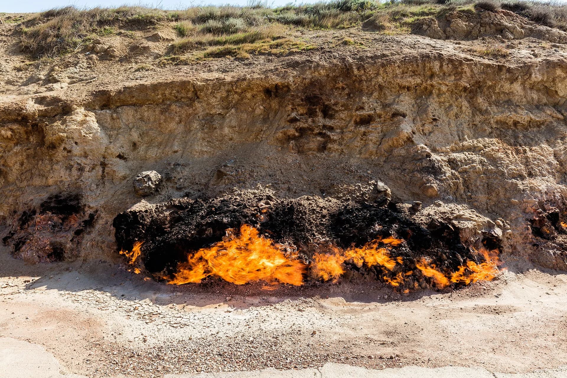 Natural gas flames along the rocky Yanar Dag hillside