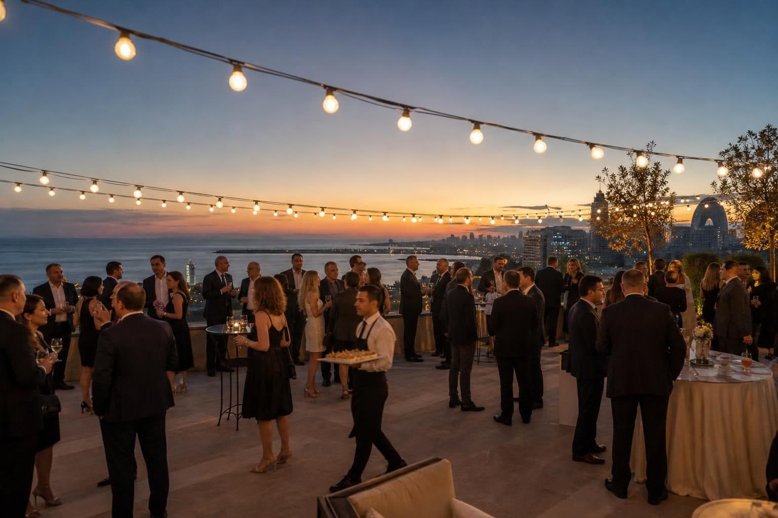 Around 50 business-formal guests mingling, men in dark suits, women in cocktail dresses, Caspian, Baku