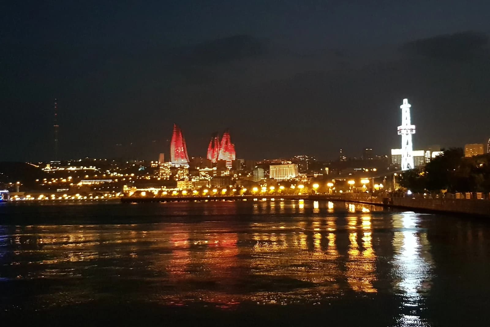 Baku waterfront and illuminated Flame Towers at night