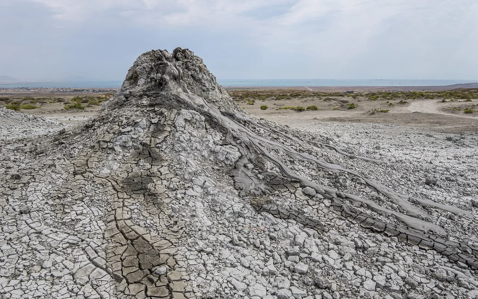 A single mud-volcano cone on the cracked Gobustan plain