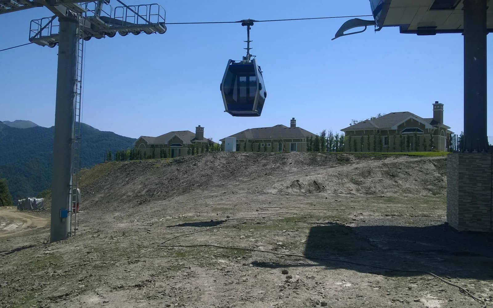 Cable-car cabin above a grassy slope in Gabala