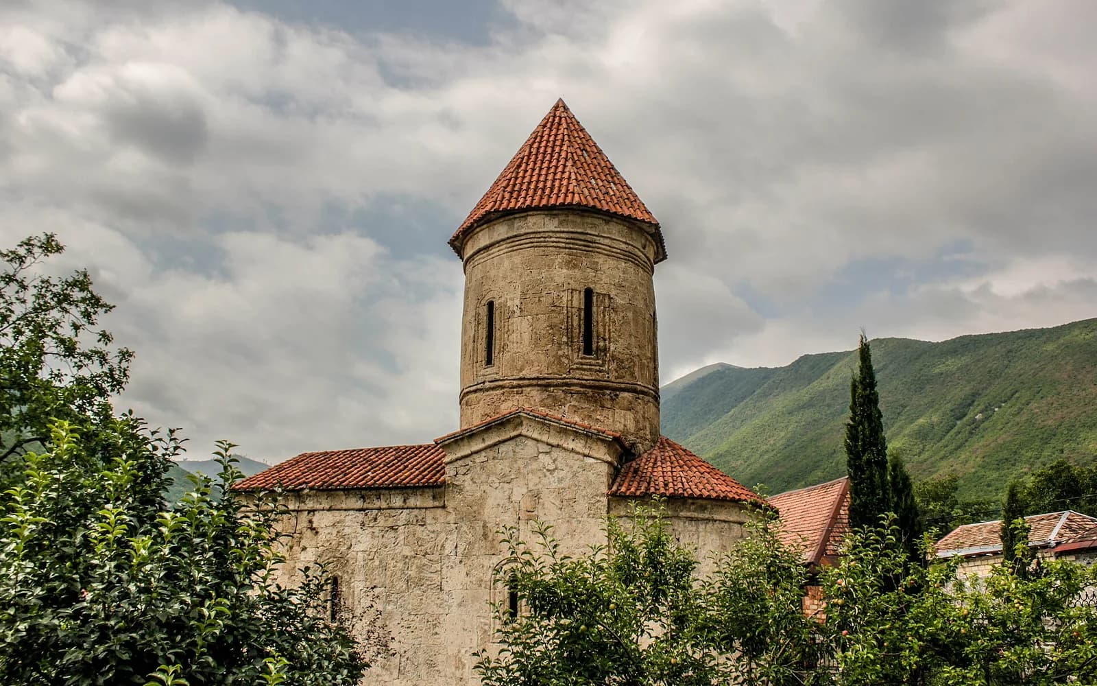 Stone exterior of the Church of Kish in its village garden