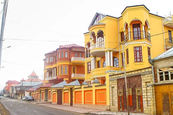 Colorful houses along a street in Red Village near Quba
