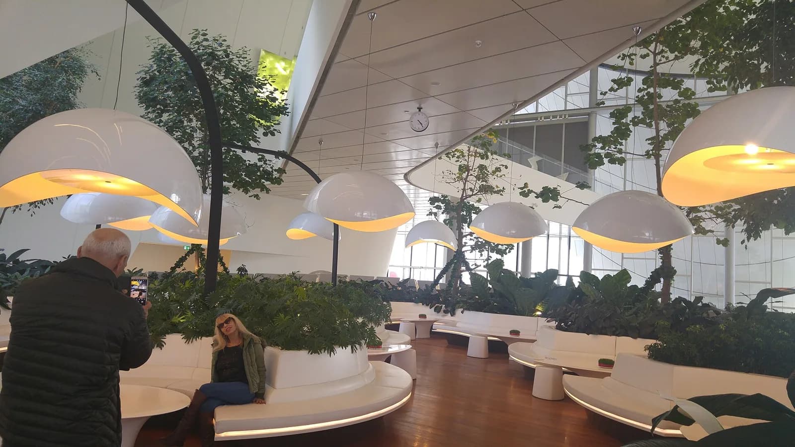 Lounge with curved seating and hanging lamps inside the Heydar Aliyev Center