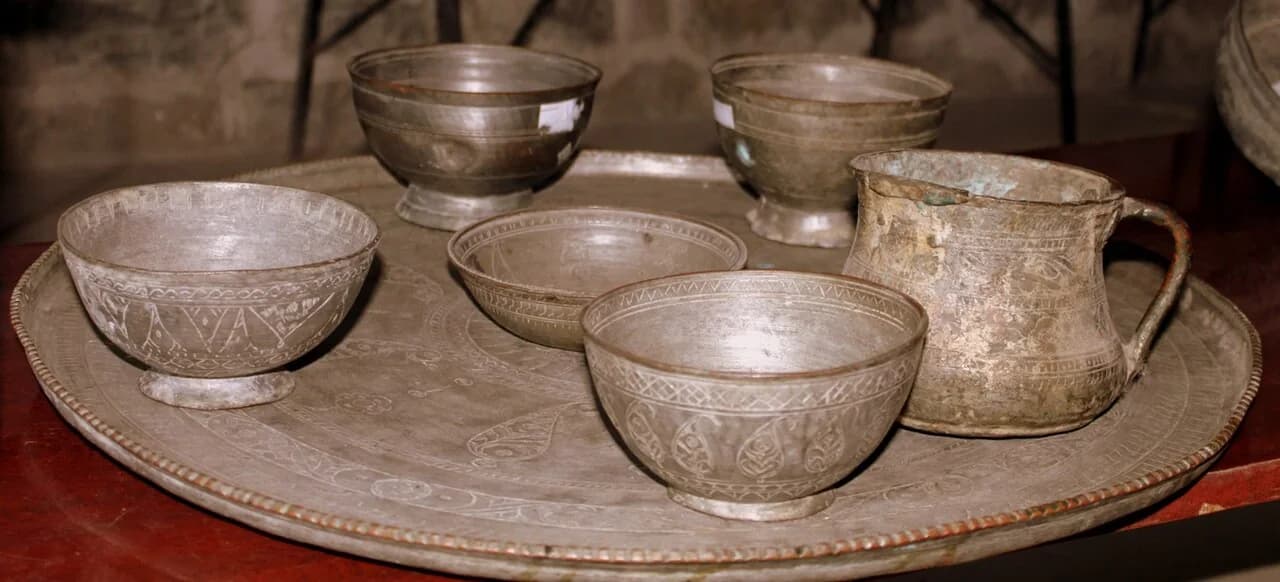 Engraved copper bowls and tray displayed in Lahij