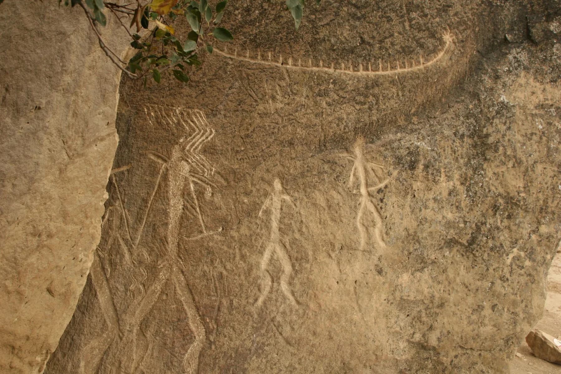 Boat and human figures carved into the rock at Gobustan