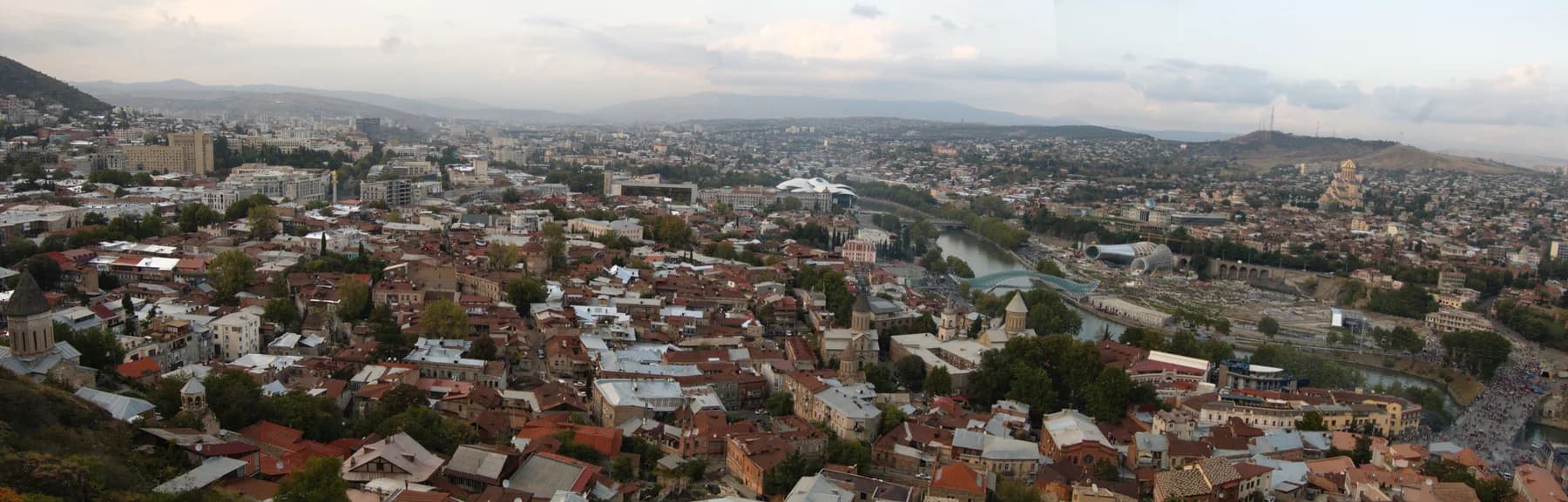 Panorama of Tbilisi with the Mtkvari River, old-town roofs and Bridge of Peace