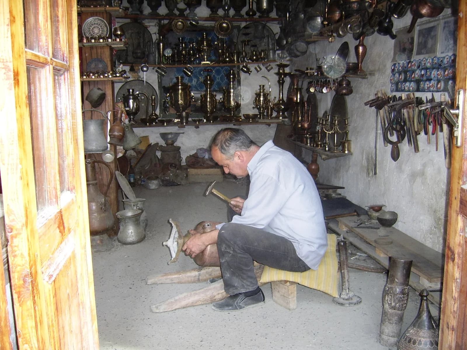 A coppersmith at work in a Lahij workshop