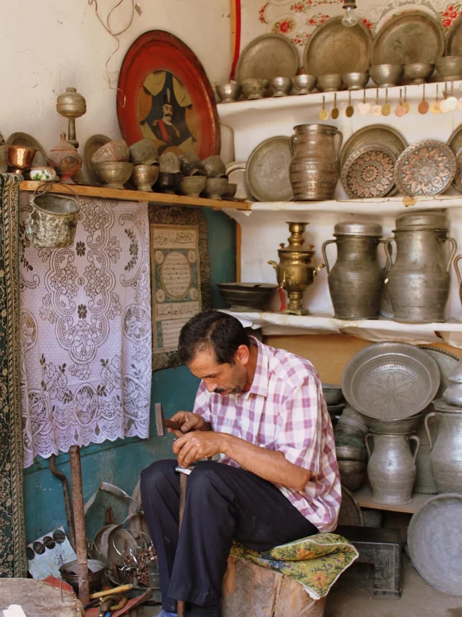 A coppersmith at work in a Lahij workshop