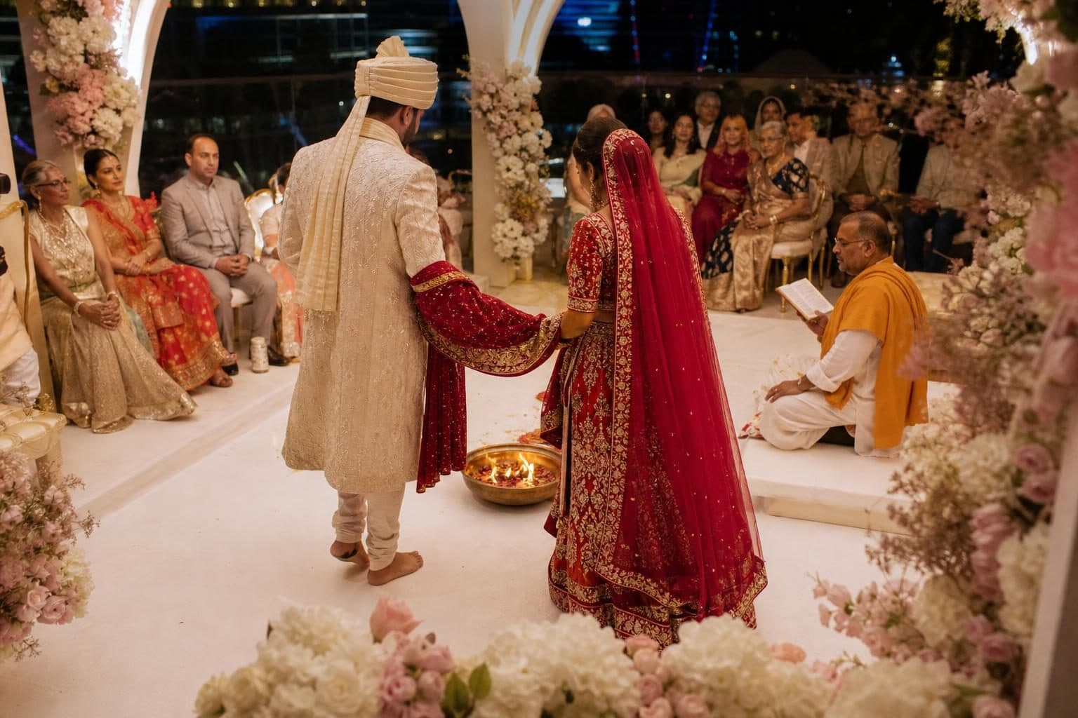 Couple walking around small sacred fire in brass bowl with small flames, hands joined and covered by red-gold cloth, Flame Towers, Baku