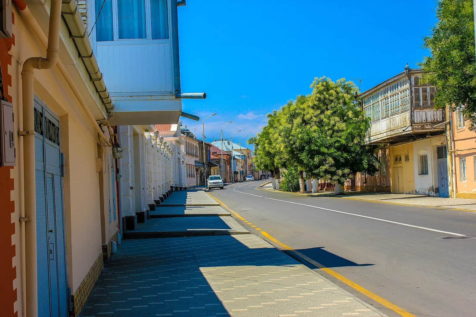 A street in Krasnaya Sloboda in summer, lined with the glazed balconies the town builds