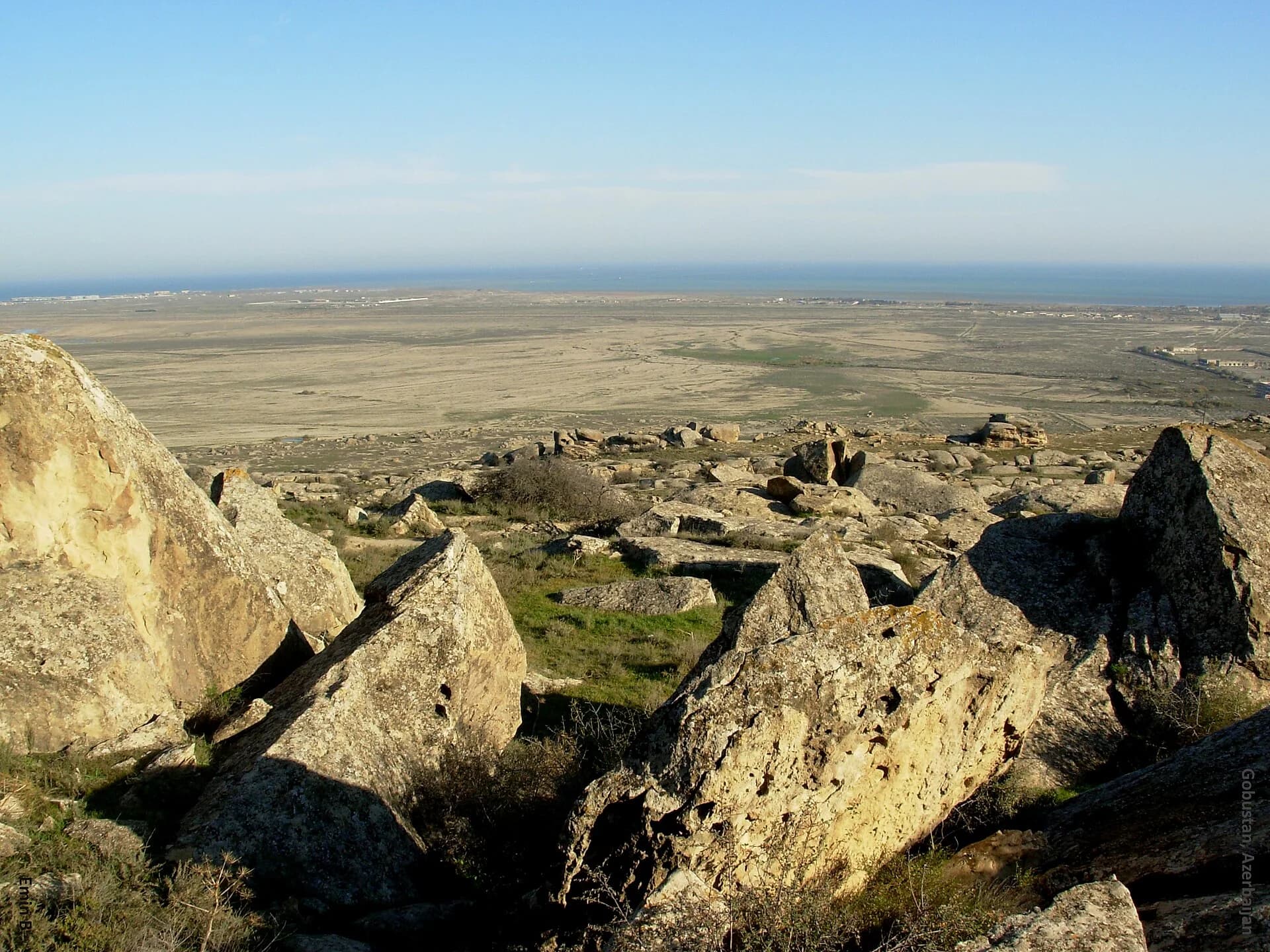 Rocky landscape of Gobustan with the Caspian Sea beyond